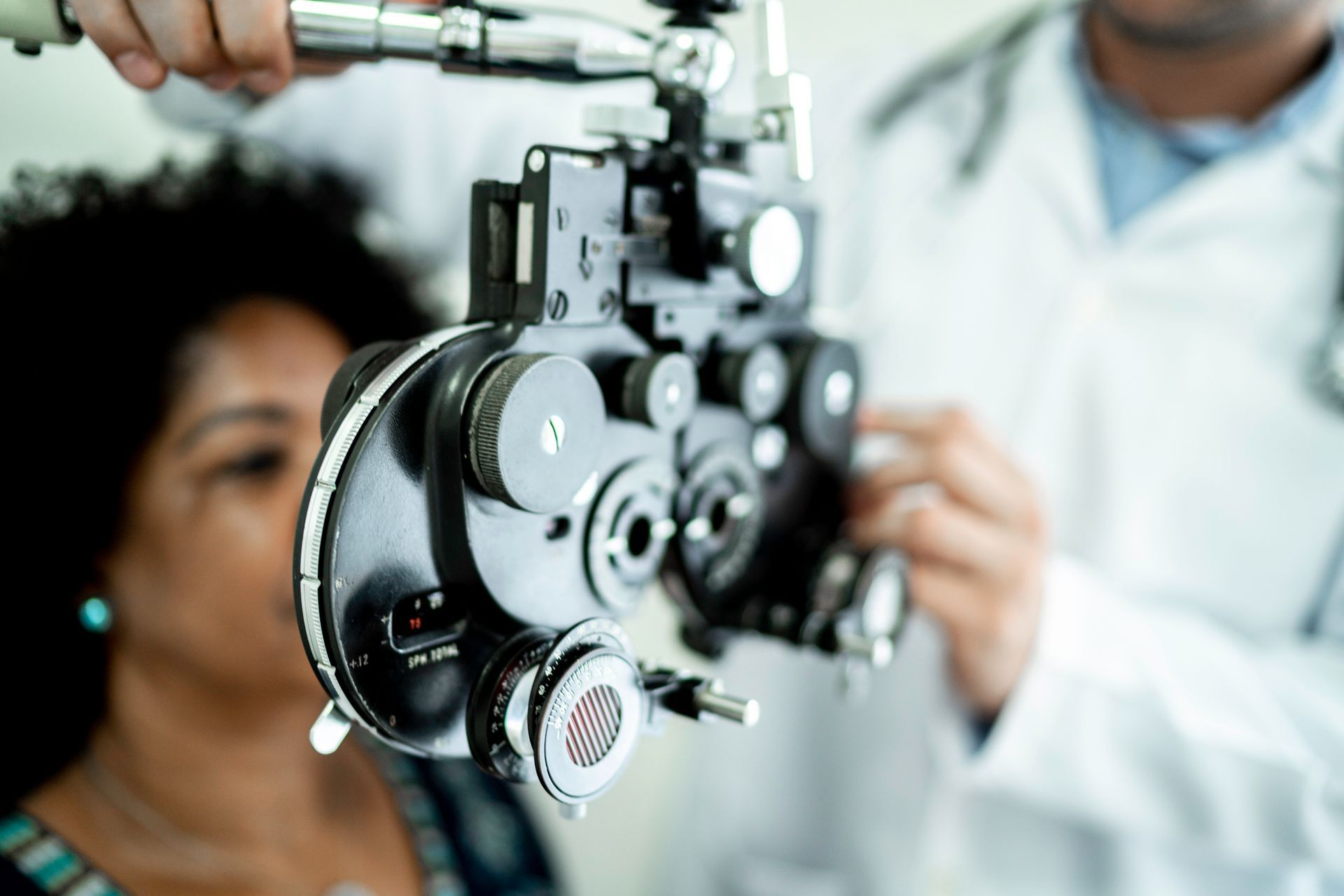 A woman is getting her eyes examined by an ophthalmologist.