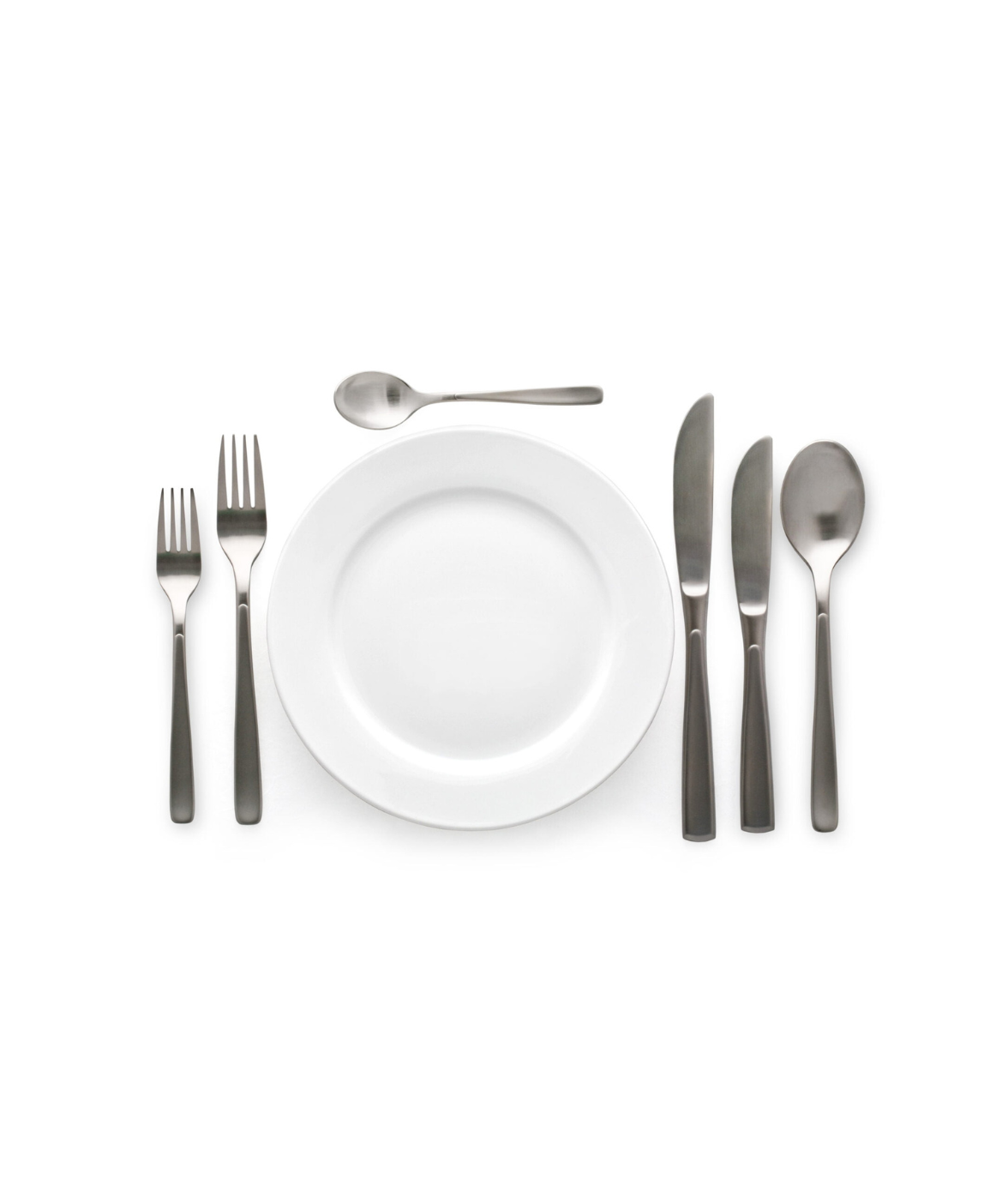 Formal place setting: plate, utensils arranged on white background.