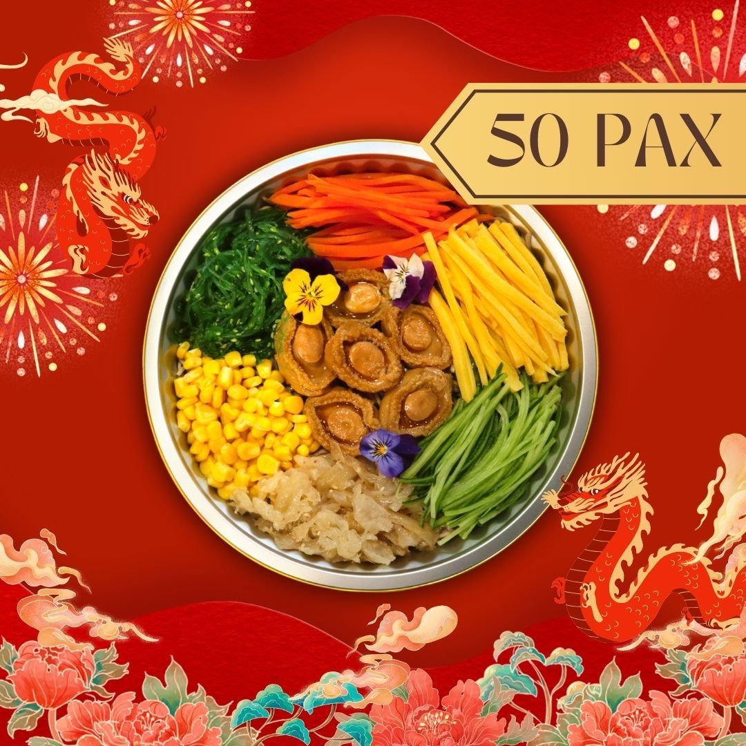 Overhead view of a large platter with colorful ingredients, for 50 people. Red and gold festive decorations surround.