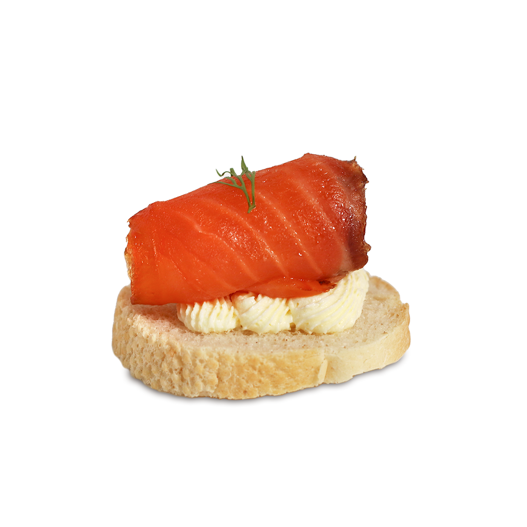 Smoked salmon canapé: salmon roll on bread slice with cream cheese, garnished with herbs.