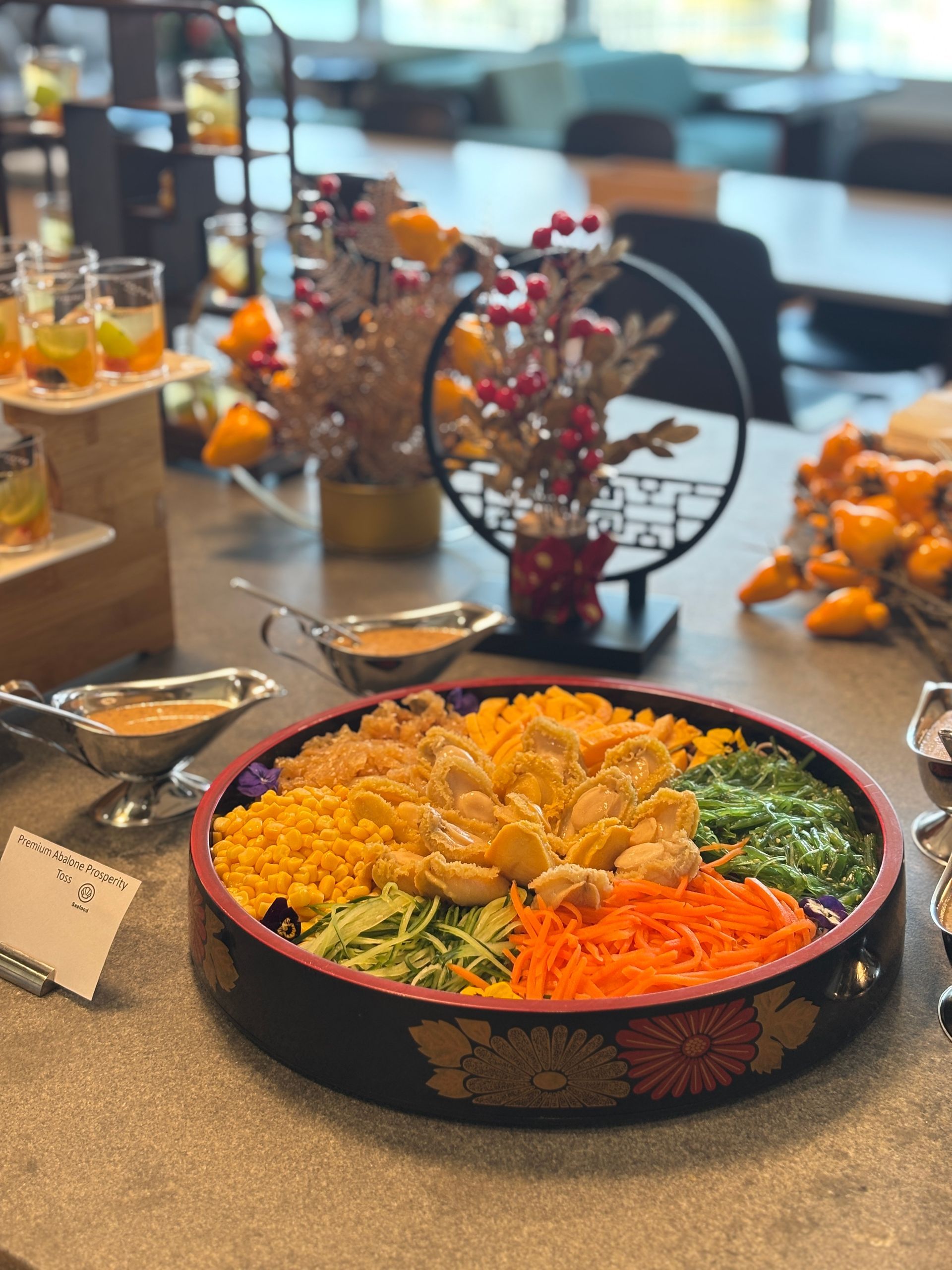 Stuffed mushrooms in a black tray, topped with breadcrumbs and bacon pieces.