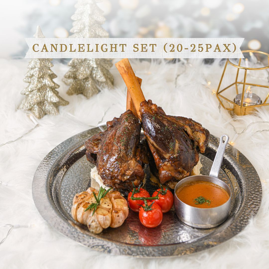 Candlelight Set: Braised meat on a platter with roasted garlic, tomatoes, and sauce.