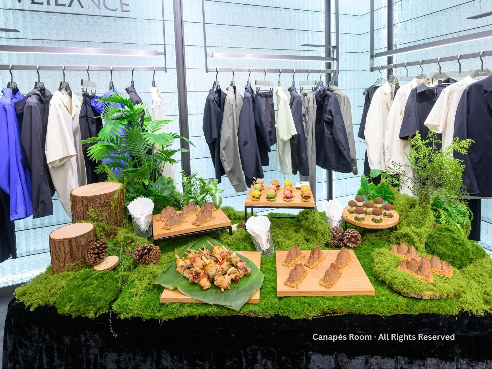 展示桌,背景中擺放著食物、綠色苔蘚和衣架。