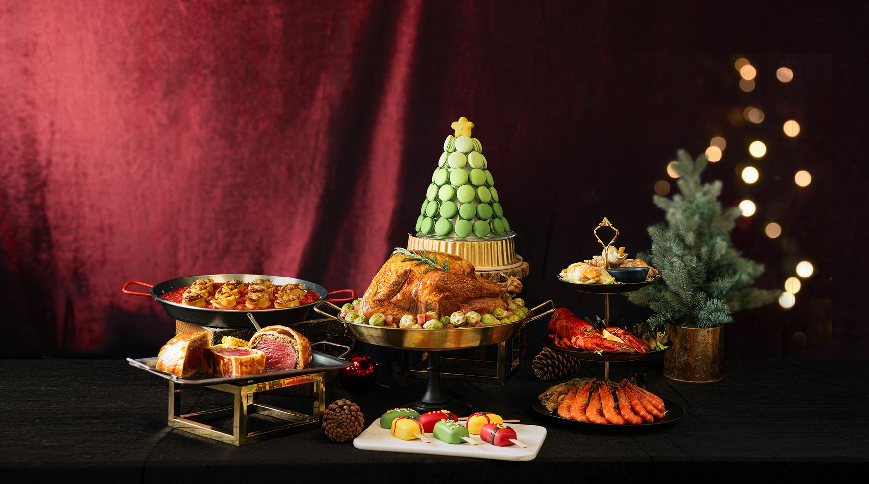 Holiday spread: A table with various foods, including a macaron Christmas tree, roast chicken, and desserts.