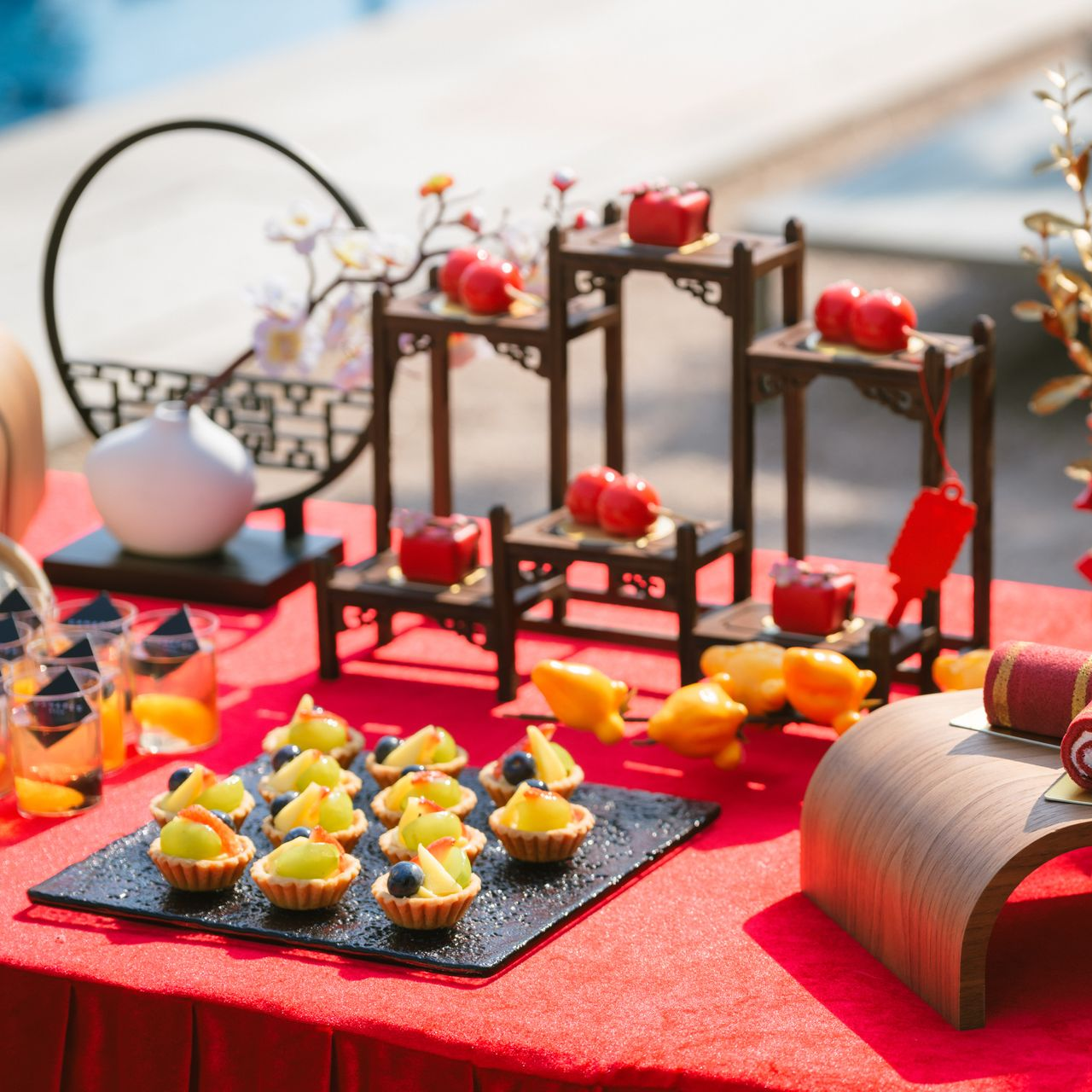 Tofu cubes in a bamboo steamer, topped with sauce and cilantro. Red background, chopsticks reaching in.