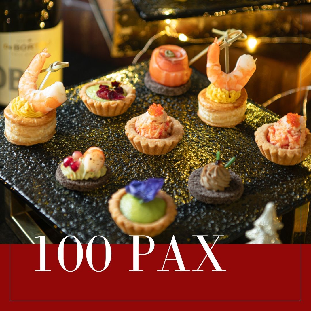 Assorted appetizers on a black platter. Text