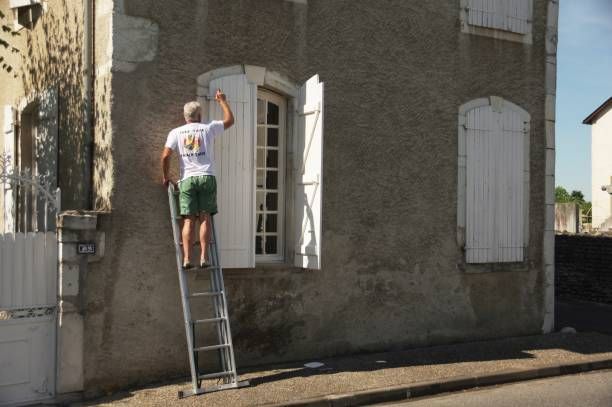 modern minimalist living room with white blinds, purple furniture, and a gallery wall.