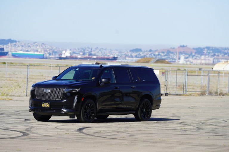 A black suv is parked in a parking lot.