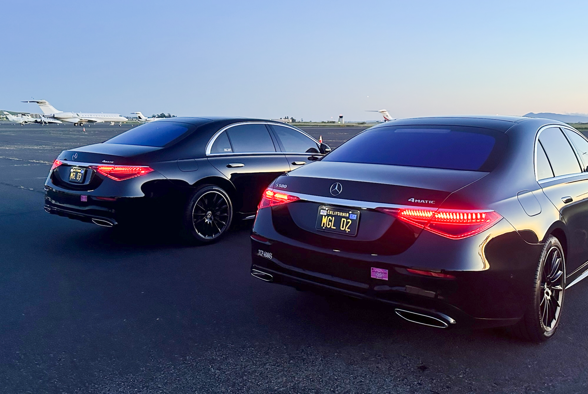 Mercedes S-Class luxury sedans lined up at private aviation terminal