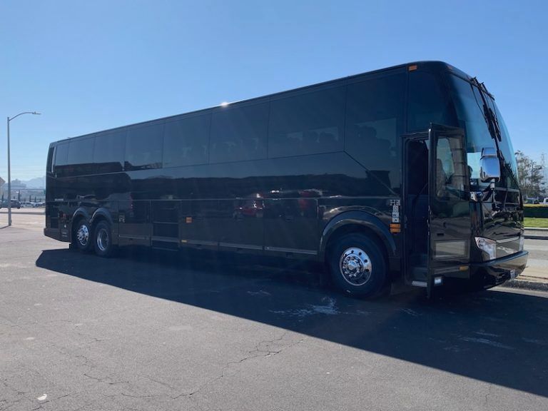 A large black bus is parked on the side of the road.