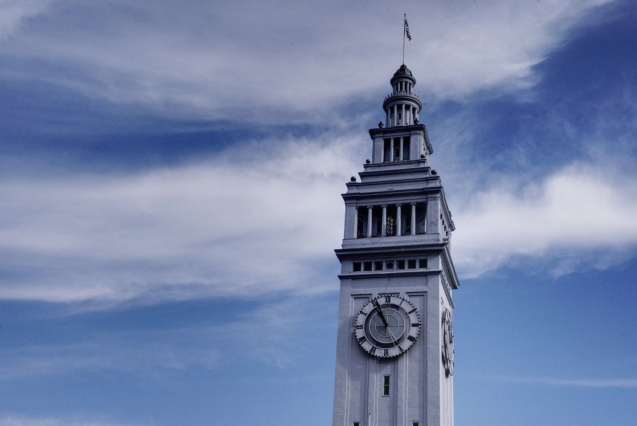 A clock tower with a blue sky in the background