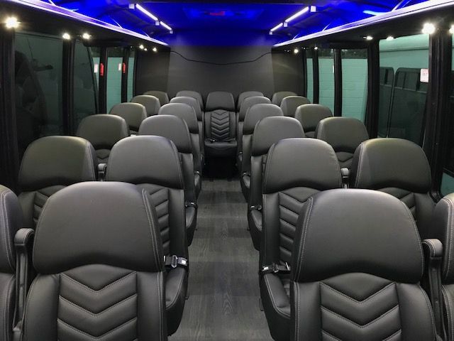 Executive mini bus interior with group seating and blue lighting