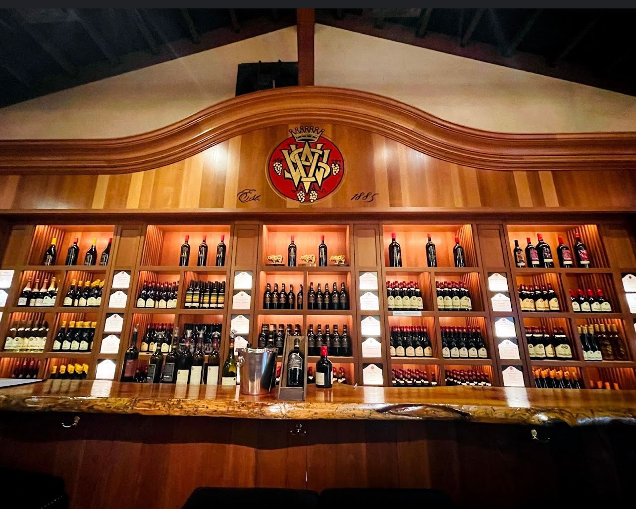 A bar with a lot of bottles of wine on it