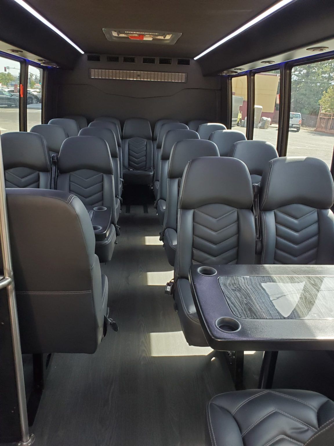 The inside of a bus with lots of seats and a table