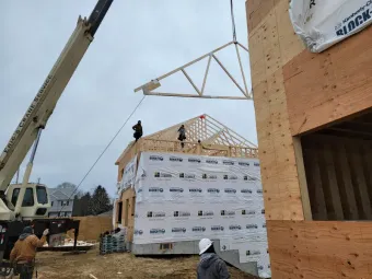 Small bathroom with white pedestal sink, green wall, and macrame window treatment.