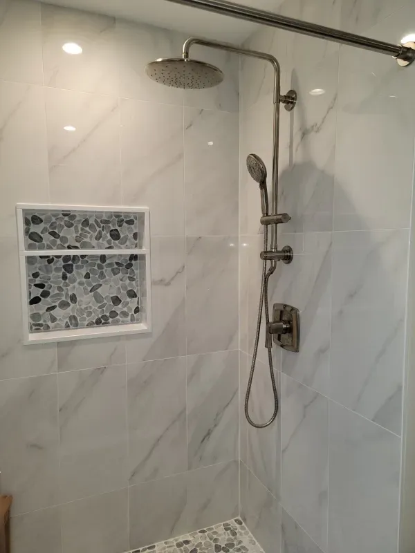 Trench dug in a grassy yard, leading to a house with black siding, and an electrical box.