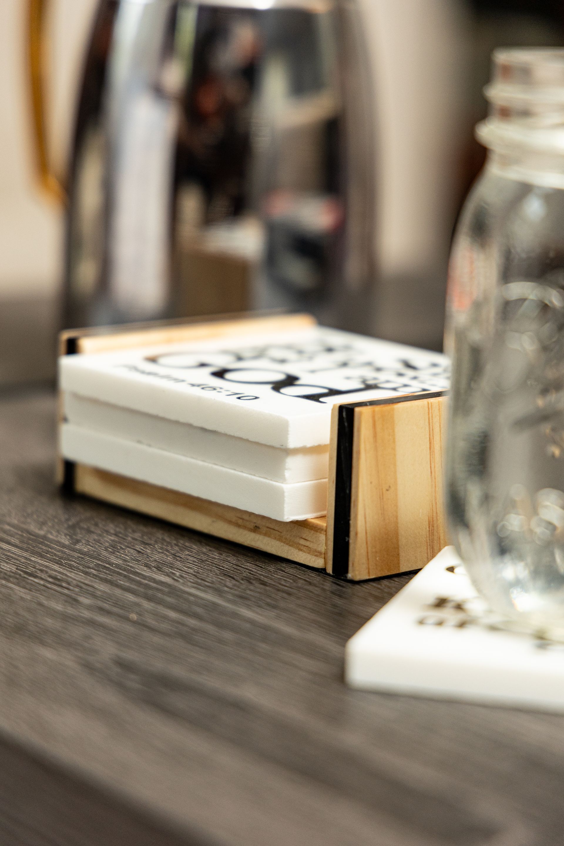 A stack of coasters sitting on top of a wooden table.