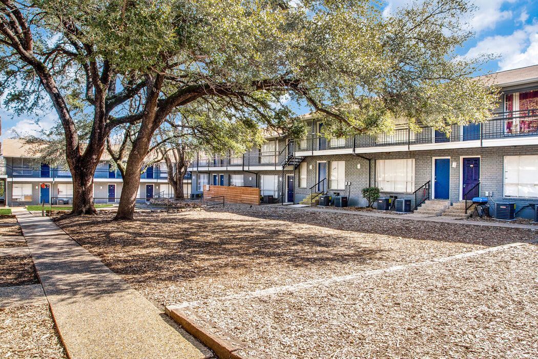 a building with a lot of trees in front of it