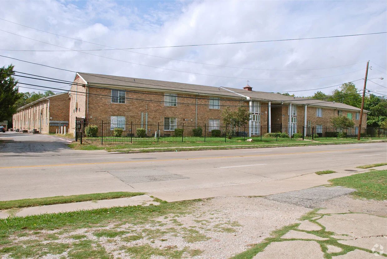 a large brick building with a fence around it