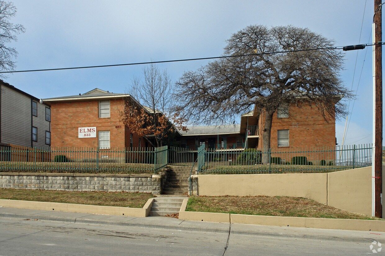 a brick building with a sign that says elms on it