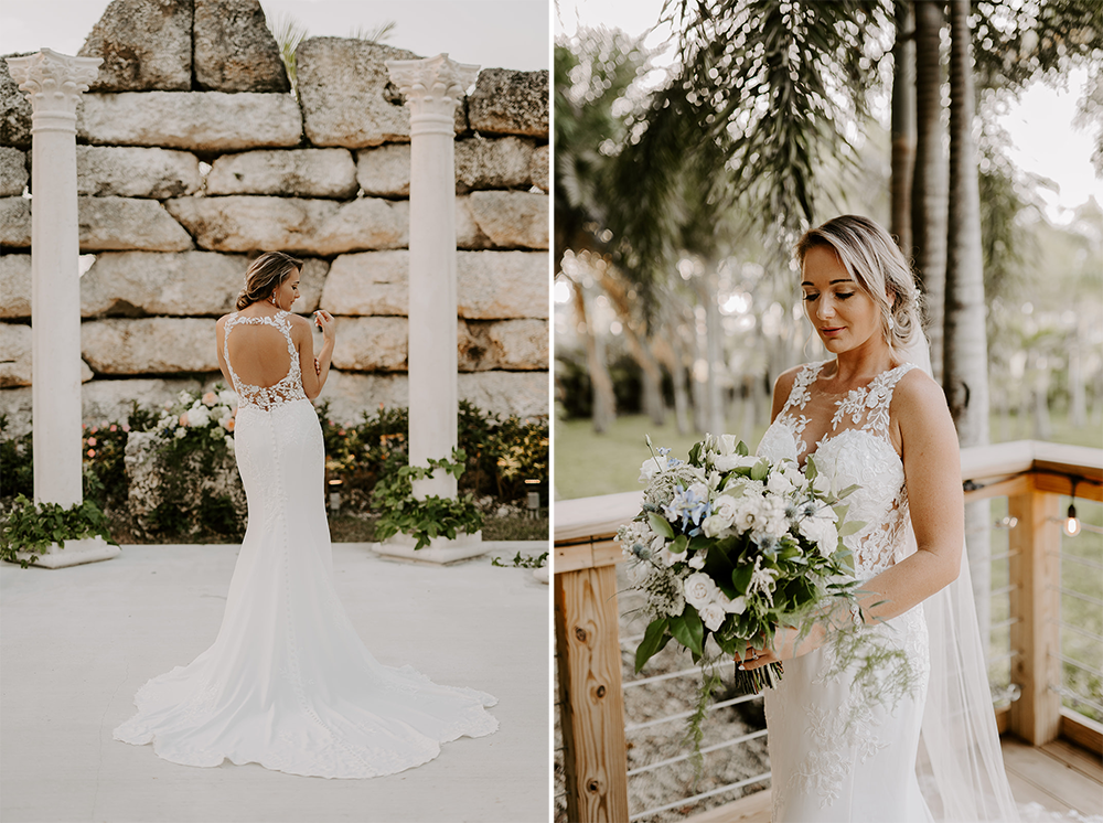 Bride in a white dress, holding bouquet, standing on a wooden deck and near stone pillars.