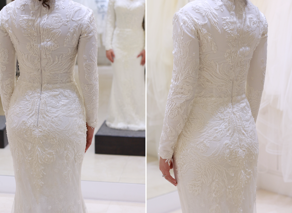Back view of a white wedding dress with long sleeves, high neck, and intricate beading.