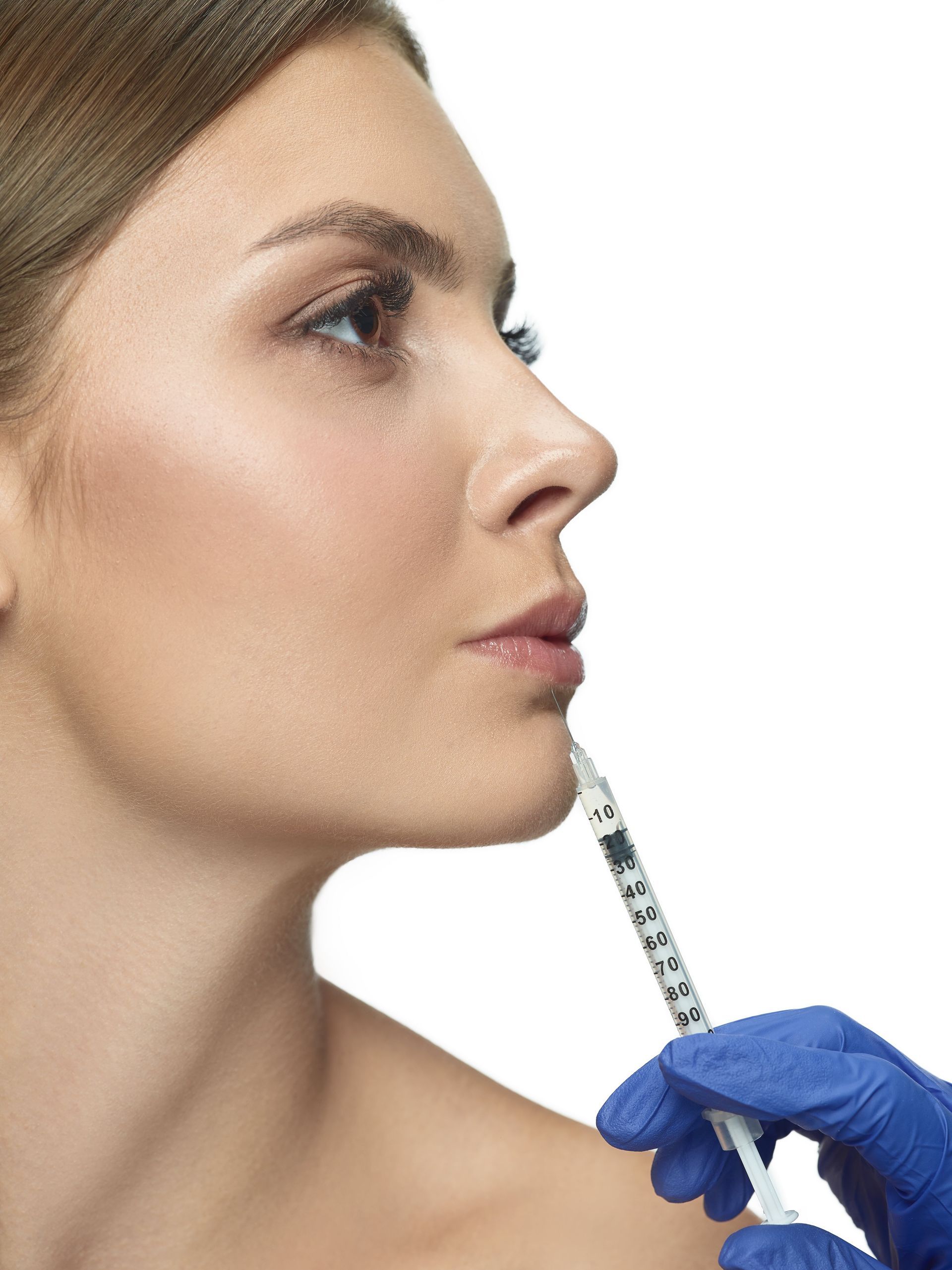 a woman is getting a botox injection in her lips