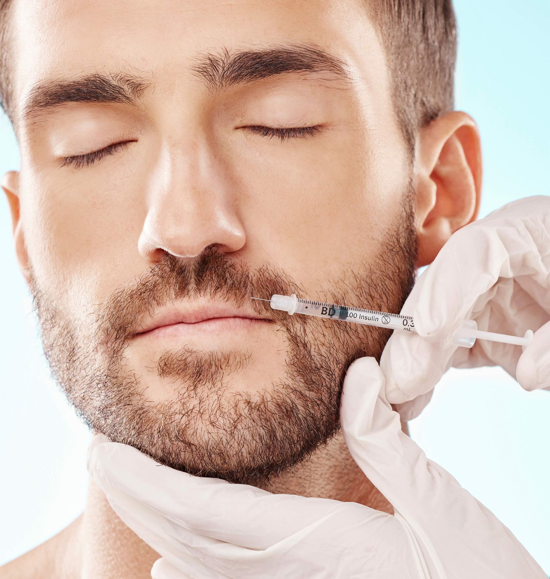 a man is getting a botox injection in his lips