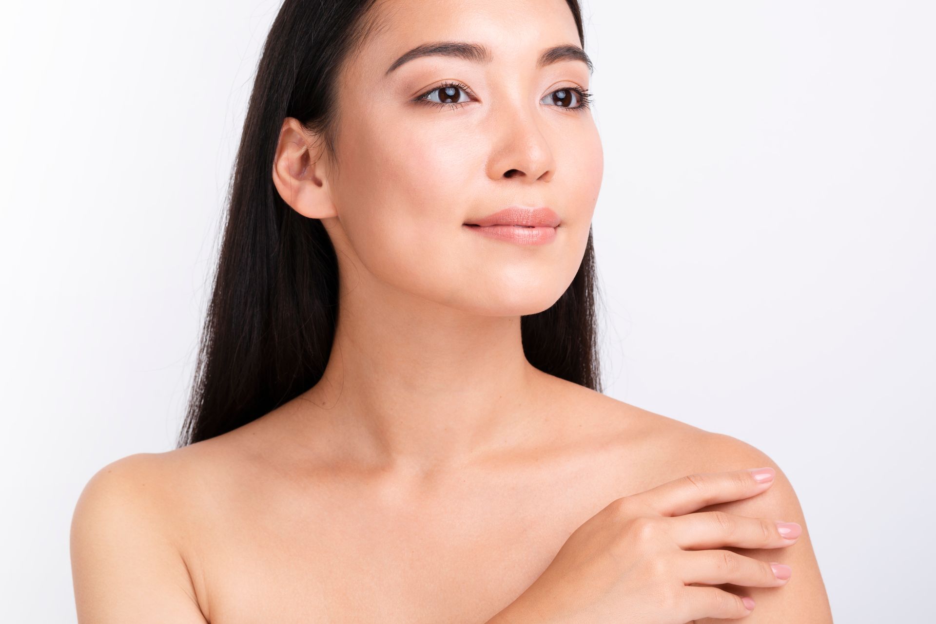 A close up of a woman 's face and shoulder with her hand on her shoulder.
