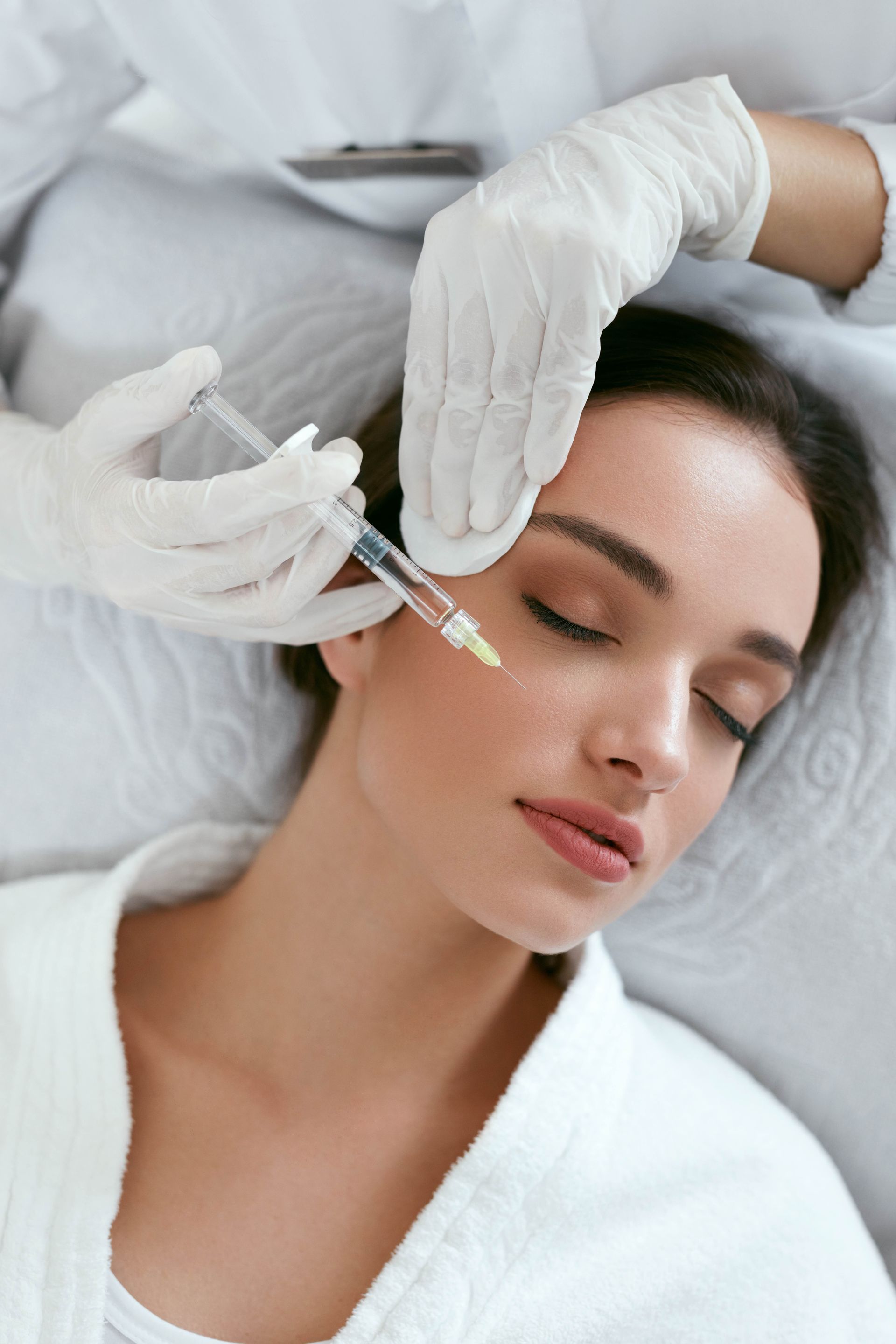 a woman is getting a botox injection in her face