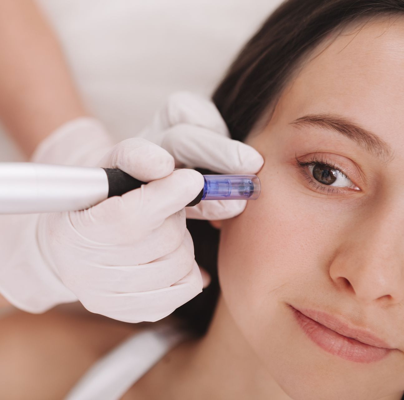 A woman is getting a treatment on her face