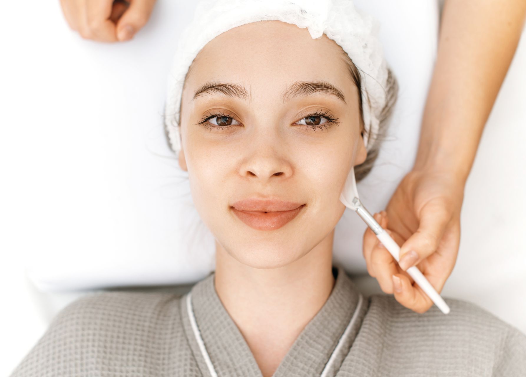 A woman is getting a facial treatment at a spa.