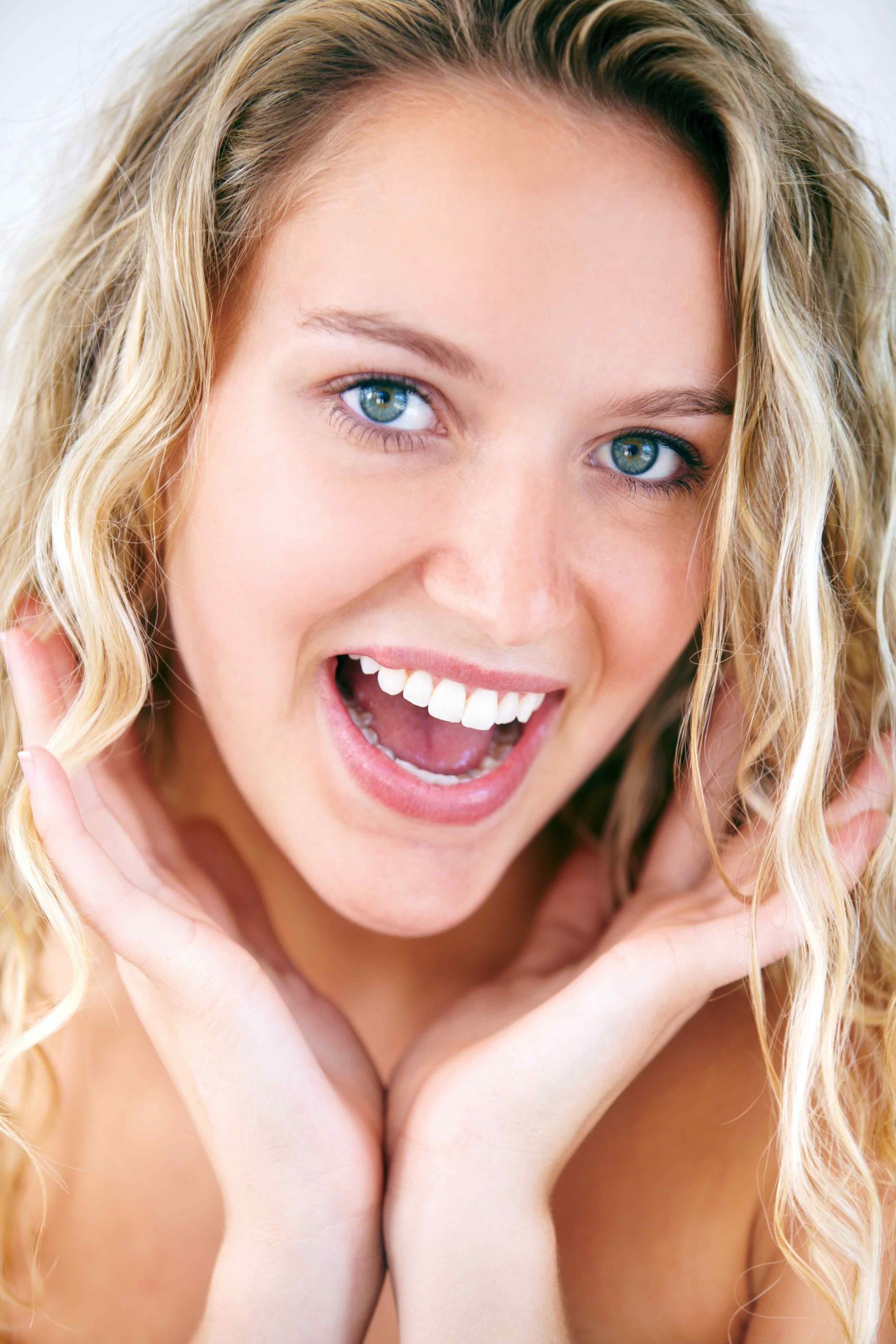a close up of a woman 's face with her mouth open