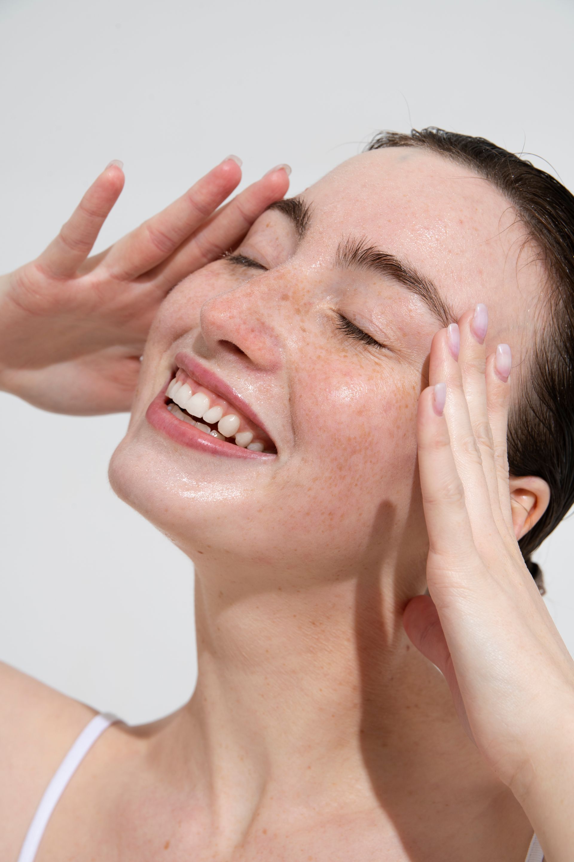 a woman is getting a facial treatment with a brush