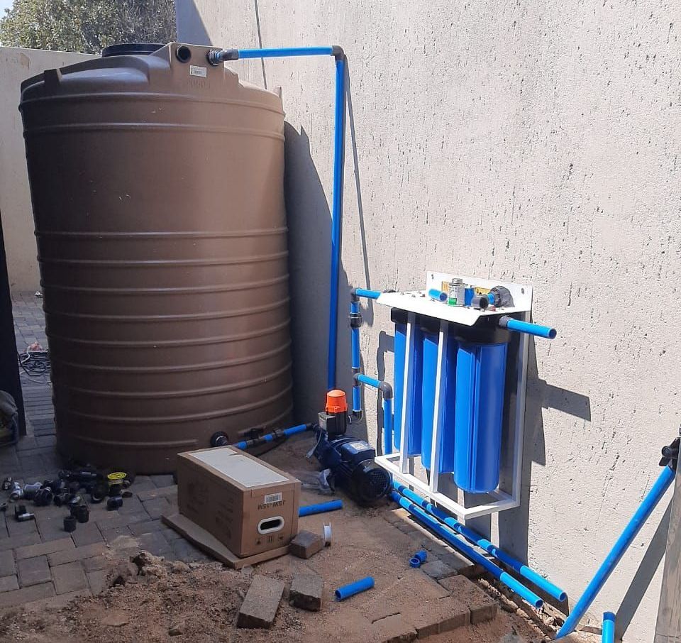A brown water tank with blue pipes attached to it