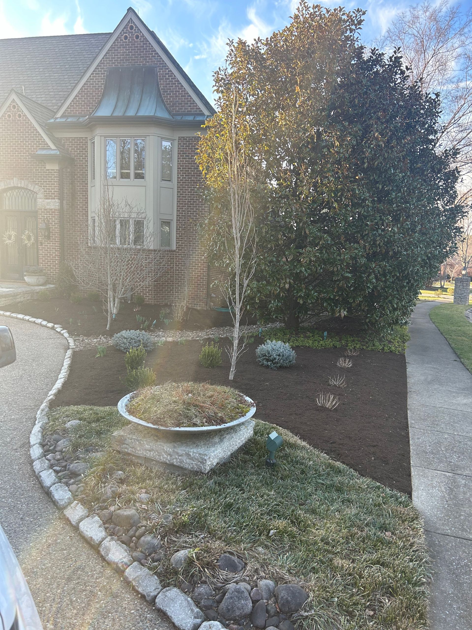 a large brick house with a large planter in front of it .|  Nicholasville, KY | Grassy Lawns
