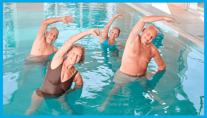 Group of seniors in a warm pool doing aqua aerobics stretches for joint pain relief in Canberra