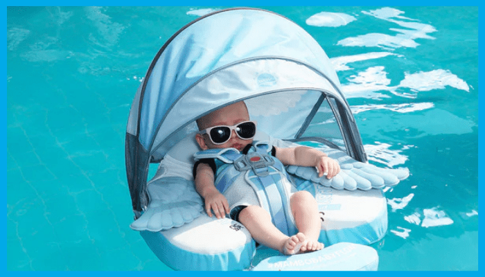 Baby relaxing safely in a UPF50+ swimming float with safety harness and sun canopy in a pool.