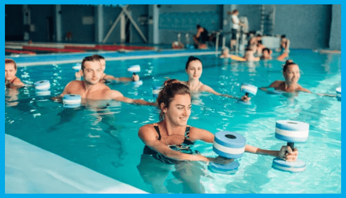Group of adults doing water aerobics with aqua dumbbells at different intensity levels, showing factors that influence calorie burn