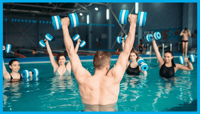 Group water aerobics class using aqua dumbbells to boost calorie burn in the pool