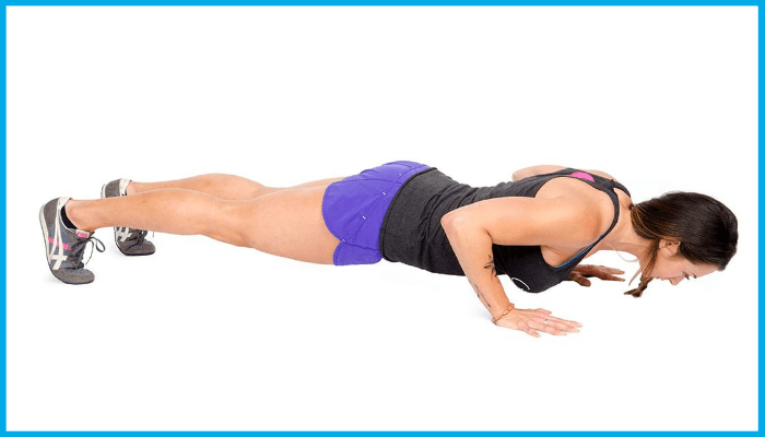 Woman performing a standard push-up to build upper body strength and endurance for swimming.