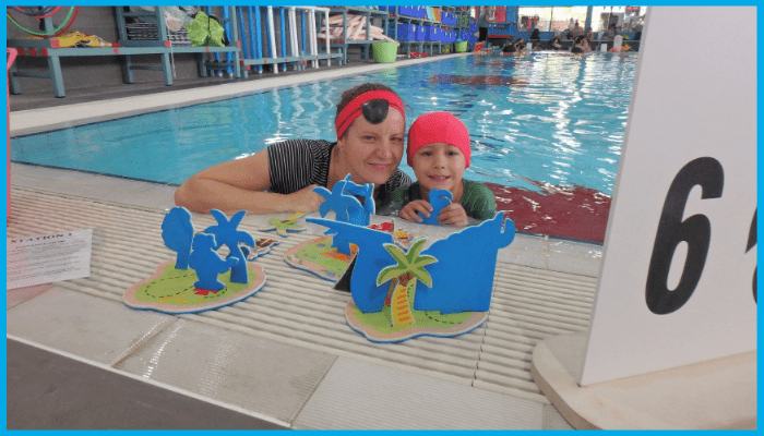 Parent and child enjoying safe swimming lesson with poolside activities in Canberra
