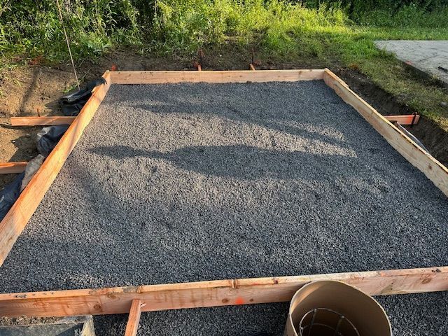 A wooden frame is sitting on top of a pile of gravel.