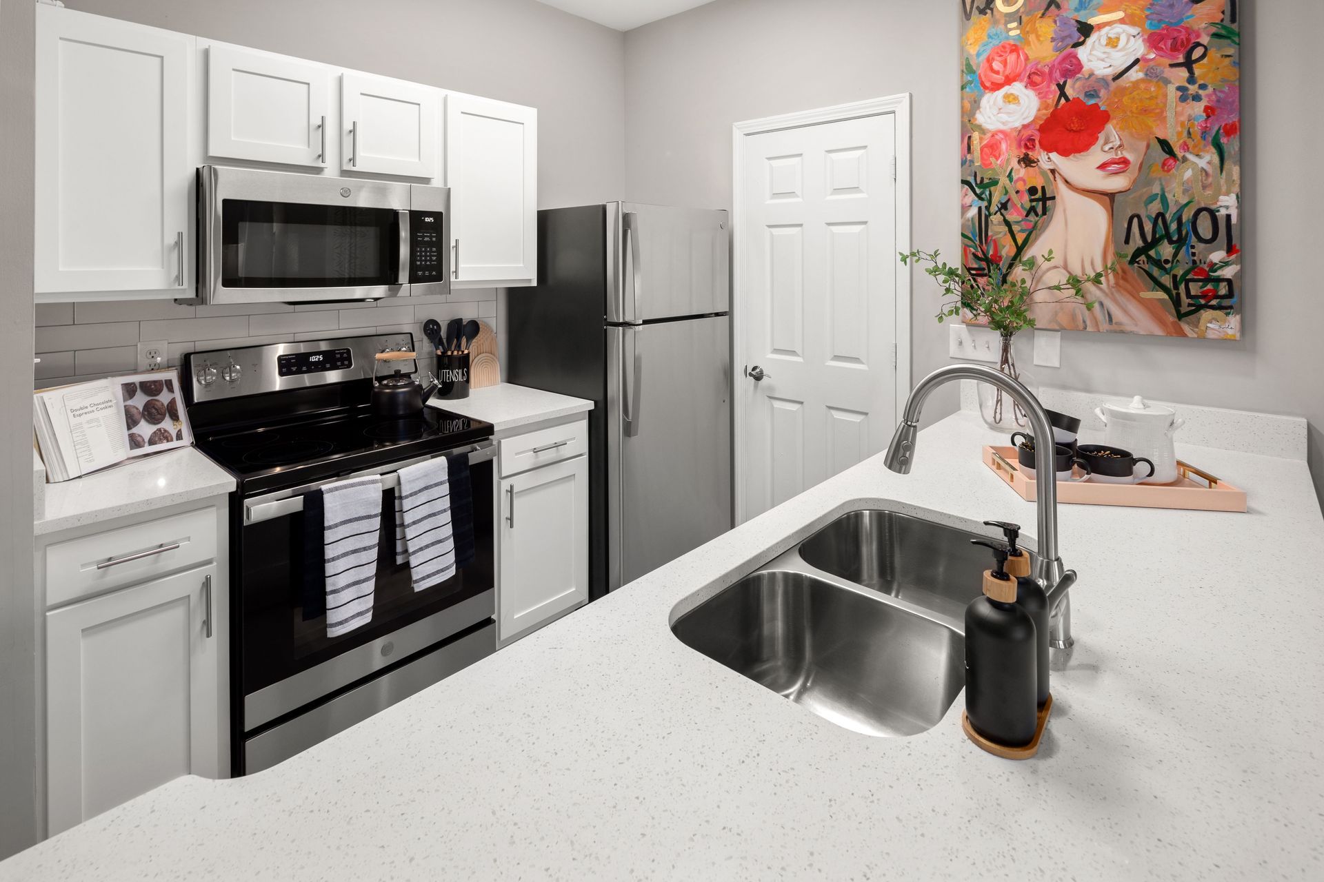 a kitchen with stainless steel appliances and white cabinets