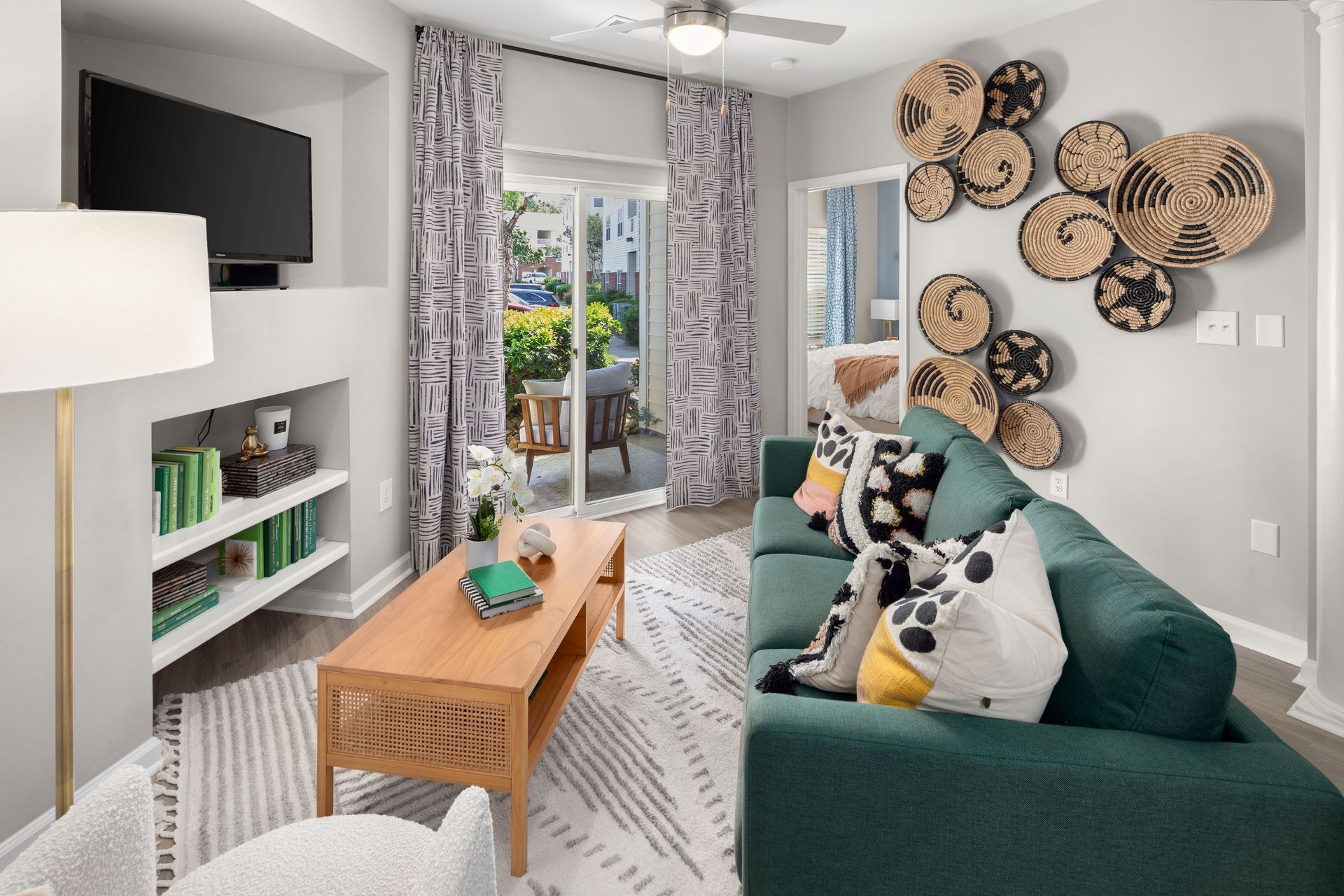 a living room with a green couch and a flat screen tv