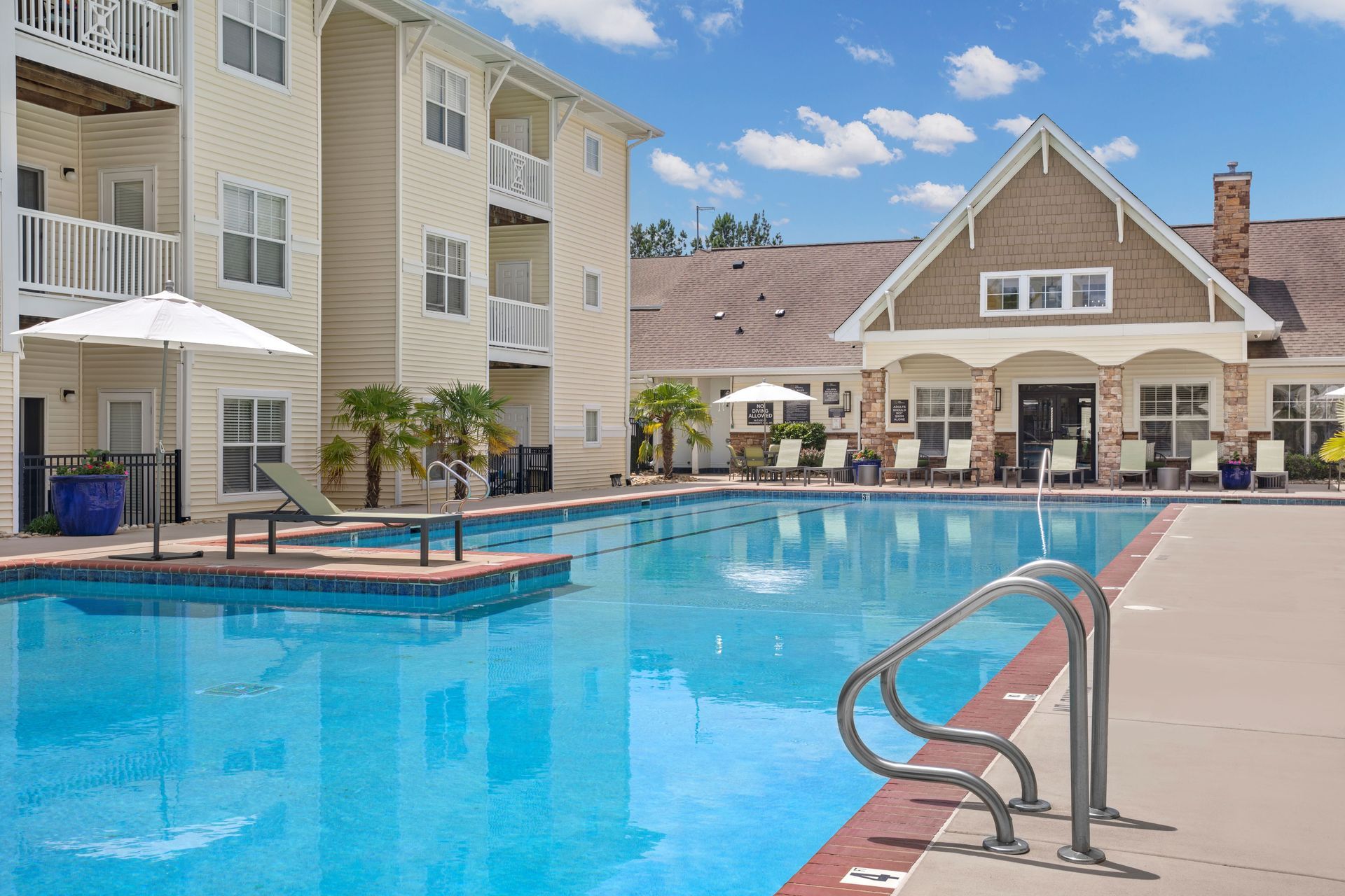 a large swimming pool in front of a building