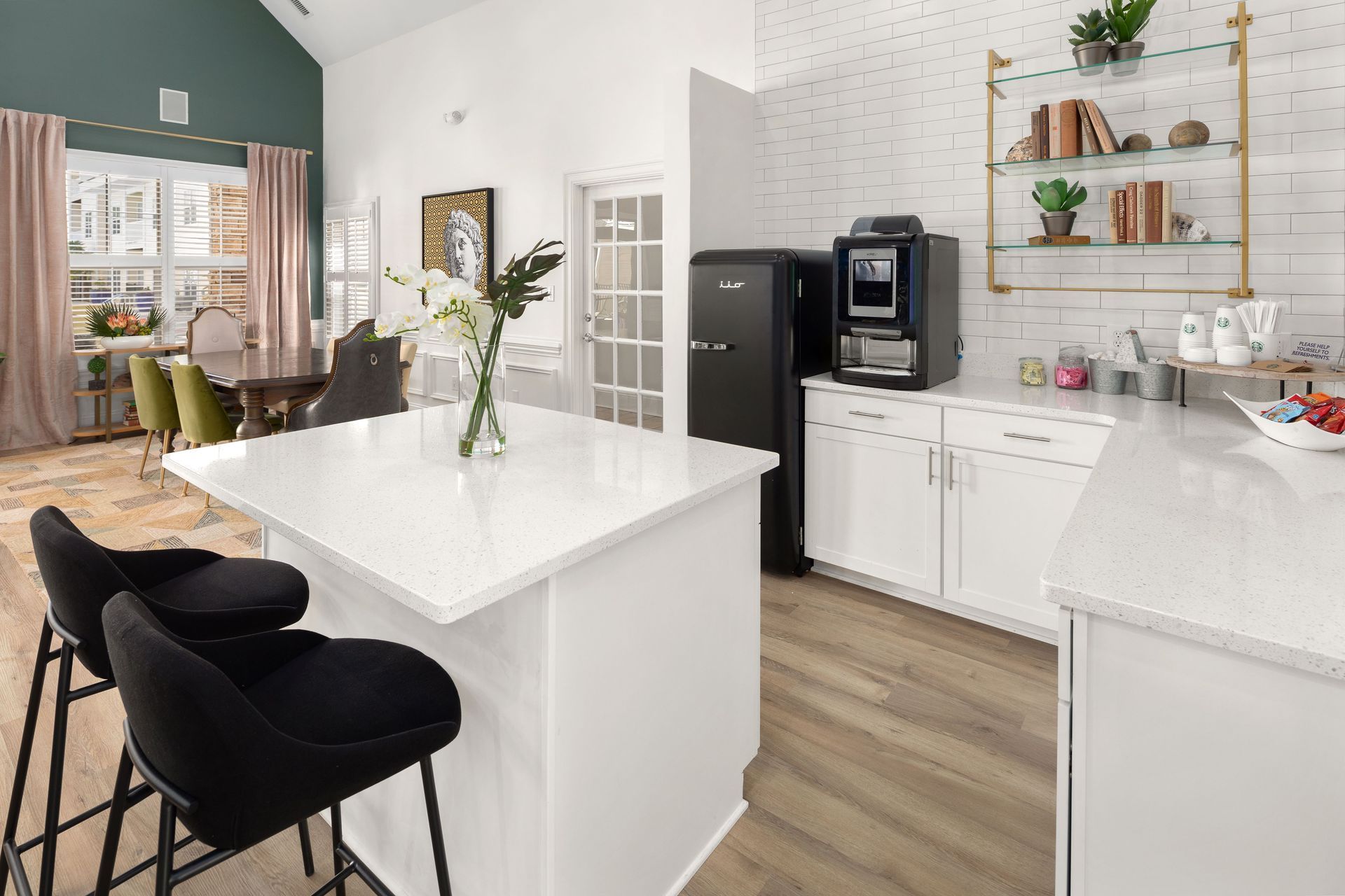 a kitchen with a black refrigerator and a coffee machine