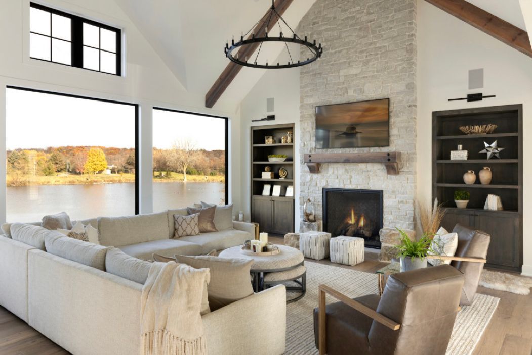 A living room with a large sectional couch and a fireplace.