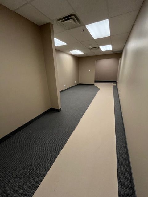 A kitchen with a sink , cabinets , and counter tops.