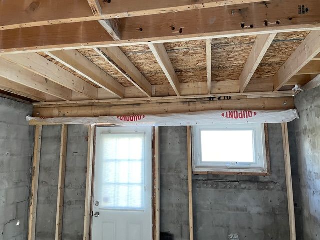 Basement construction: wooden frame with a door and a window.